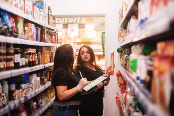 istock Two women working with a tablet in a grocery store 1421040499