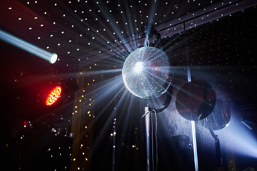 mirror ball with light beams, club light music