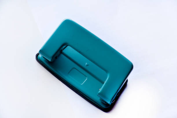 istock A white stapler and a green hole punch on a white background. Stationery on a white background. 1421042856