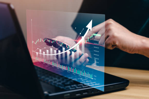 istock Businessman using mobile phone apps and laptop to perform stock trading operations in financial markets to buy or sell stocks. cryptocurrency investment risk, profit concept. economic growth chart. 1421042887