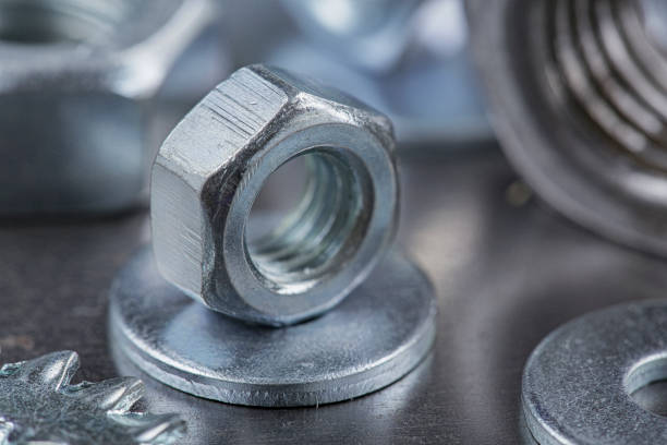 istock set of different nuts, bolts, screws, washers and drill bits,thread tap and mill cutters on steel plate background. Locksmithing deal. 1421042922