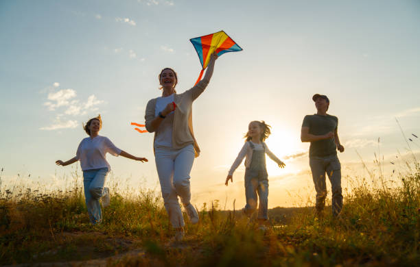 istock Happy family at sunset 1421049554
