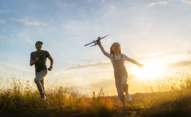 istock Happy family at sunset 1421049561