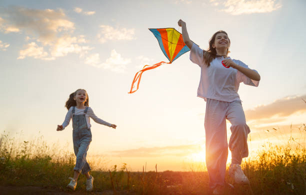 istock Happy kids with kite 1421049577