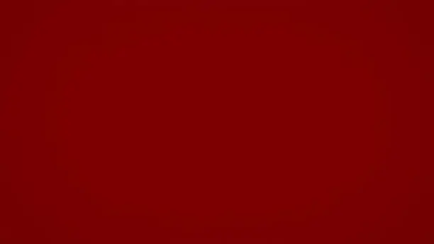 Photo of Plain dark red solid background without anything on it for any impact luxury background.