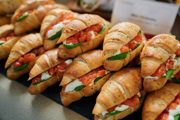 istock Stacks of croissant sandwich at event 1421052307