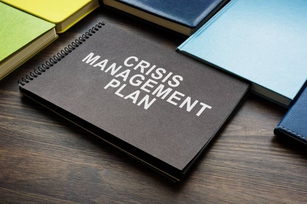 Crisis management plan and notepads on the desk.