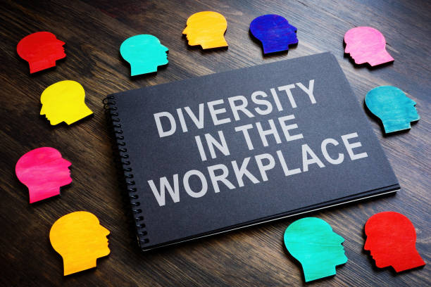 istock Colored figures and an inscription Diversity in the workplace on a notebook. 1421053143