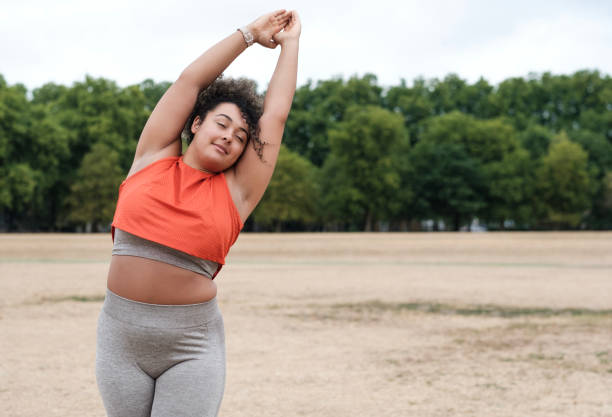 istock A young mixed race woman is stretching in a park. 1421055855