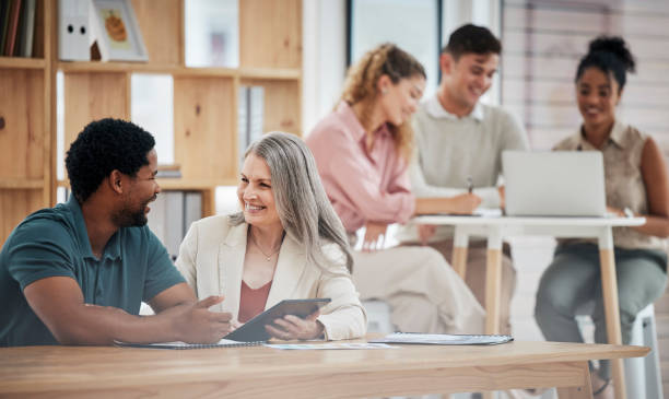 istock Digital marketing, planning and discussing strategy while diverse colleagues sit together to talk about growth development and innovation. Happy entrepreneurs with a positive mindset using tablet 1421057602