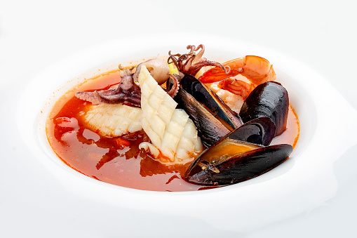 Traditional Marseille Bouillabaisse fish soup with prawns, mussels tomato,lobster, squid.