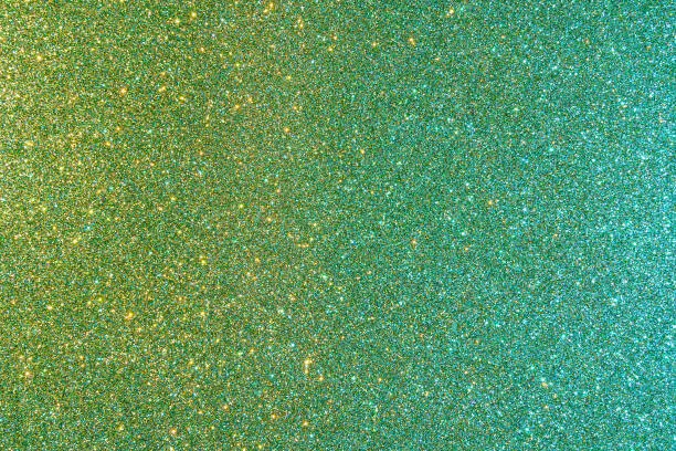 Photo of Background with sparkles. Backdrop with glitter. Shiny textured surface. Dark moderate cyan lime green