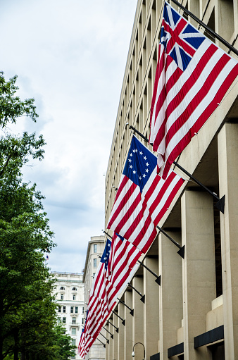 American flags on the FBI Building in Washington DC during summer day