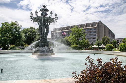 Bartholdi fountain and U.S. Department of Health & Human Services in Washington DC during summer day