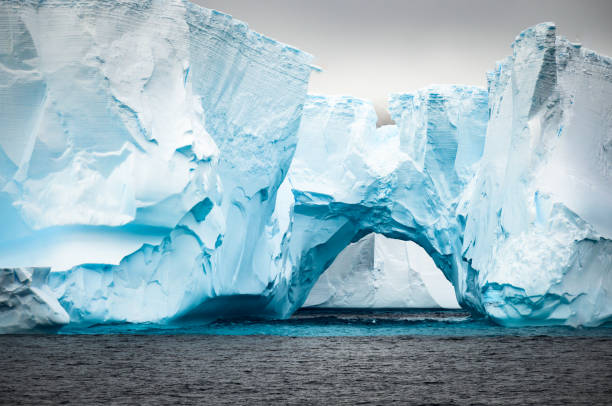 istock Natural Tunnel that has Formed in this Tabletop Iceberg in the Antarctic Sound 1421068912
