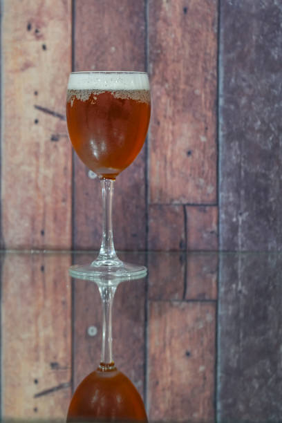 Ice cold beer glass on wooden background. Copy space