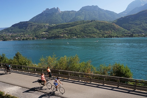 Bredannaz, France - 16 August 2022: Looking at part of the cycle path that circumnavigates Lake Annecy. The cycleway along the west shore is traffic free.