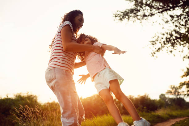istock Mother and daughter playing in the nature 1421071122