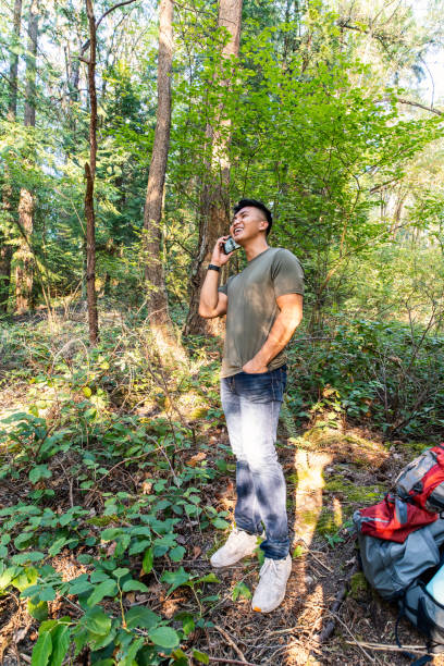 istock Man Talking on Phone in Woods 1421072644