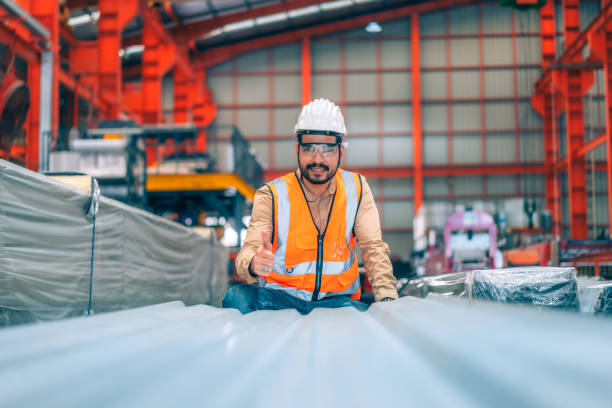 istock Portrait professional confident Asian man industrial engineer/worker/technician with safety hardhat are check, inspect metal sheet for quality control in production steel manufacture factory plant 1421073638
