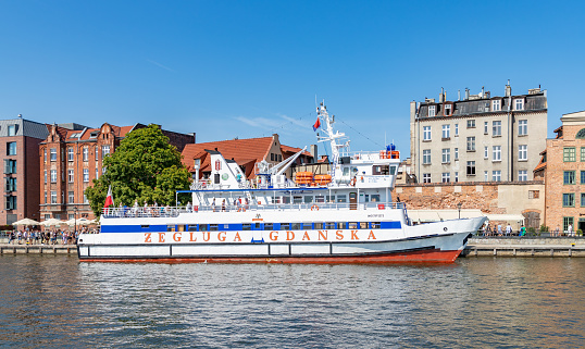 Gdansk, Poland - August 13, 2022: A picture of a tour ferry docked in Gdansk's Motlawa River.