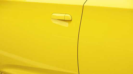Detail and doors of yellow colored car