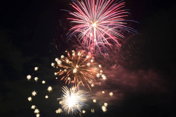 istock Aerial view of bright fireworks exploding with colorful lights against dark night sky on US Independence day holiday 1421075261