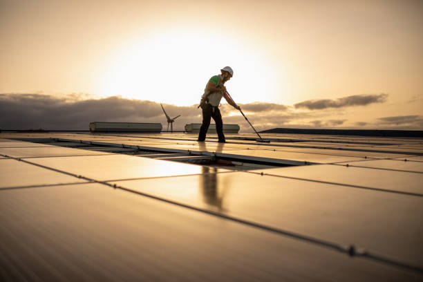 istock Professional worker cleaning solar panels on a roof 1421080014