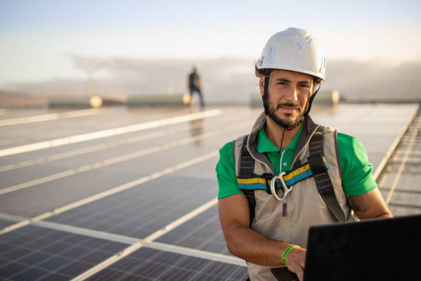 Checking productivity at solar power plant with laptop stock photo