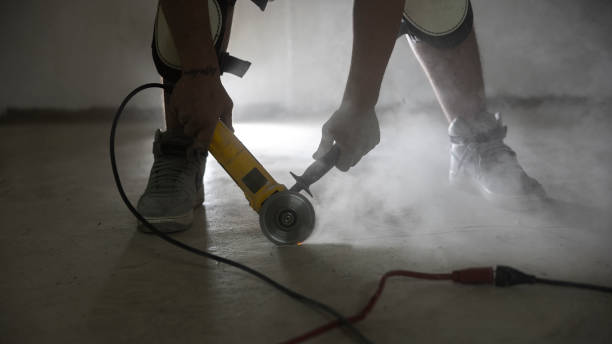 istock Concrete dust is thrown out by angle grinder used for a construction job - basement waterproofing. 1421081676