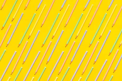 Colored pens on yellow background