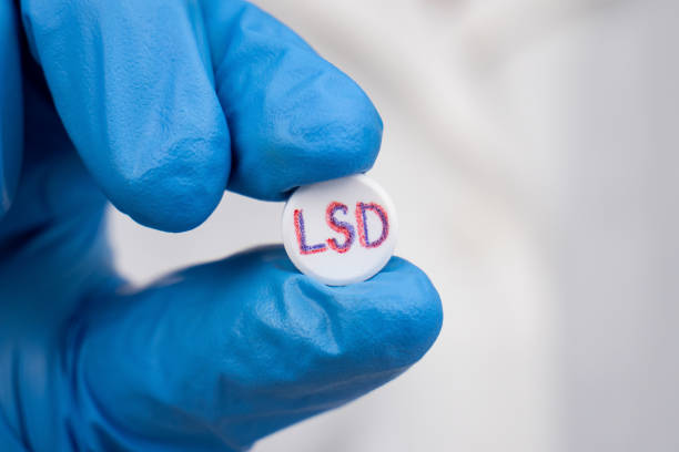 pill for depression,hand doctor holding soaked lsd tablet stock photo