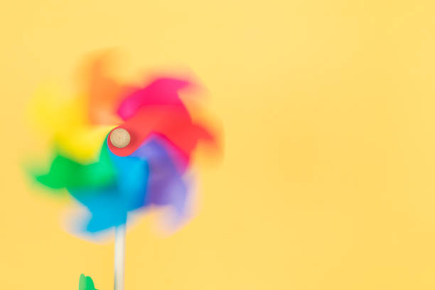 istock Moving coloured pinwheel on yellow background. Copy space. Thematic lgtbq. 1421088854