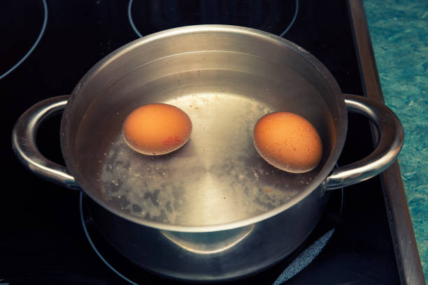 istock two boiling eggs cooked in water for breakfast in a metal pan 1421088922