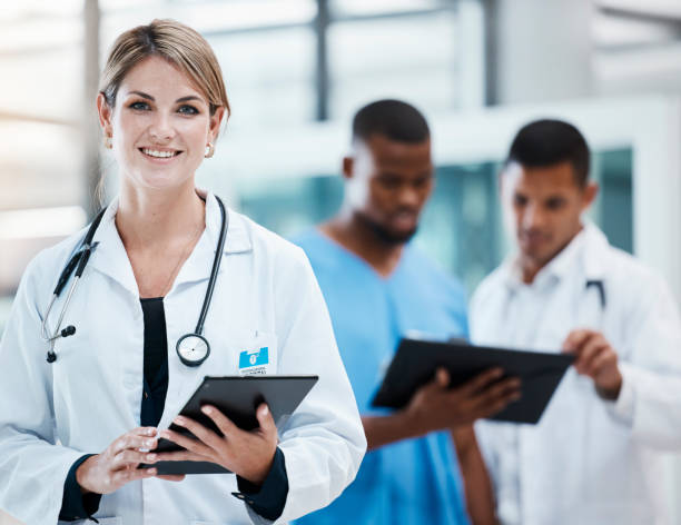 istock Science, innovation and health care with leading doctors working on digital tablet, planning together. Diverse healthcare professionals discussing medicine, treatment researching a cure for cancer 1421089247