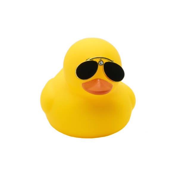 istock Yellow duck toy with black sunglasses isolated on white background 1421089328