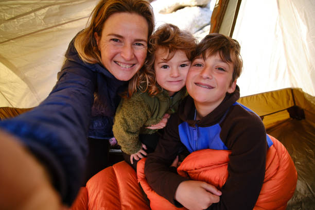 istock Mother taking selfie with kids in tent 1421090715