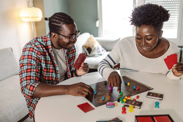 istock Young people enjoying at home and playing board game 1421091919