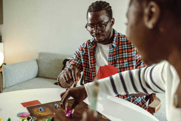istock Young people playing board games at home 1421092619