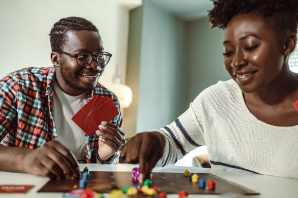 istock Young people playing board games at home 1421092891