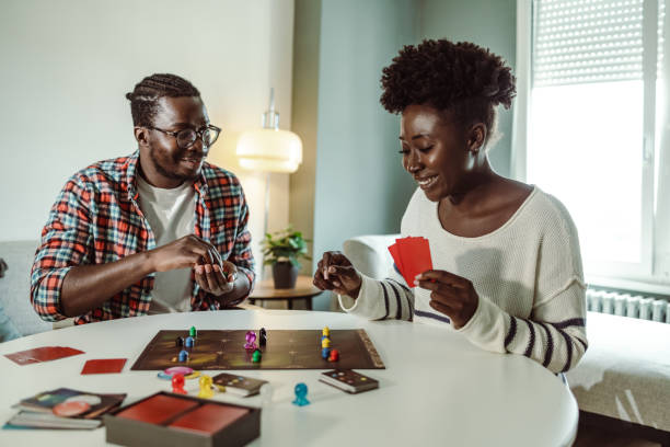 istock Young people enjoying at home and playing board game 1421092892