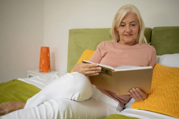 istock Woman relaxing and reading a book 1421093963