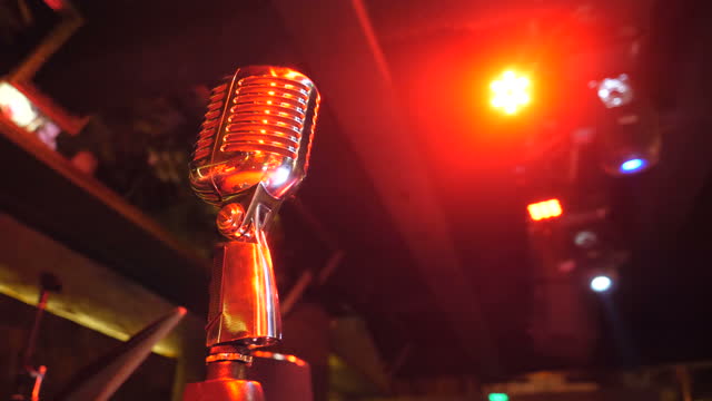 Retro style Microphone stands on a tripod in nightclub