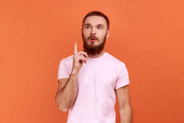 istock Man pointing finger up and looking amazed about sudden genius idea, got solution. 1421095888