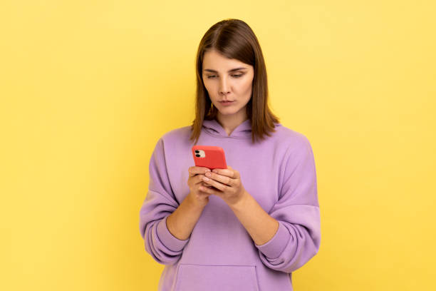 istock Calm serious woman reading message on smartphone, using mobile device for communication browsing web 1421096833