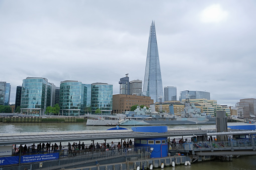 London, United Kingdom, August 22, 2022. View to Southbank of the River Thames with Shard skyscraper tower. and HMS Belfast Modern contemporary architecture. Overcast summer day outdoors