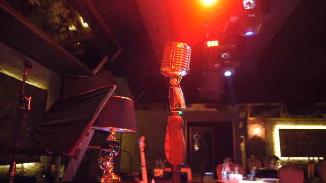 Retro style Microphone stands on a tripod in nightclub