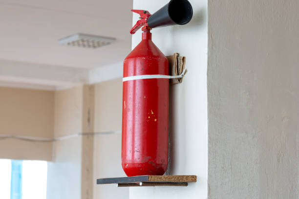istock Portable hand-held fire extinguisher mounted on the wall inside the room 1421099068