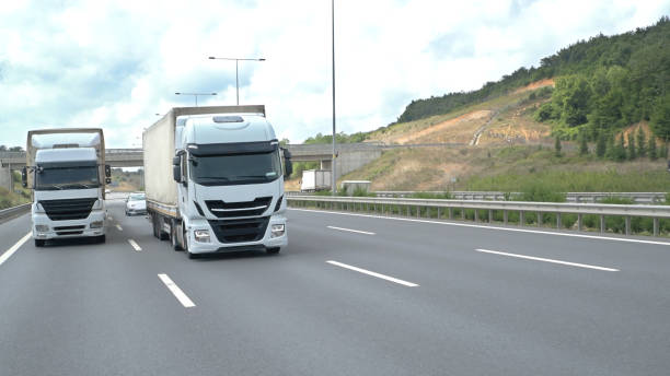 istock Two Truck Side By Side On Road 1421099170
