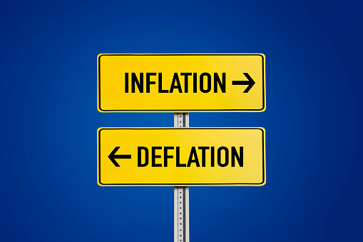 Inflation and deflation road sign on blue background